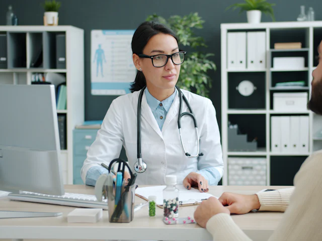 A doctor talking with a patient in a clinic office