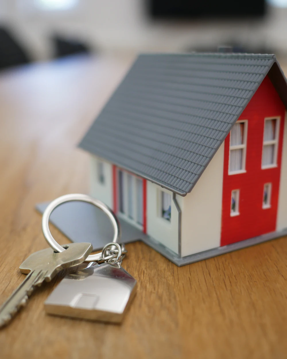 House keys next to a small model house